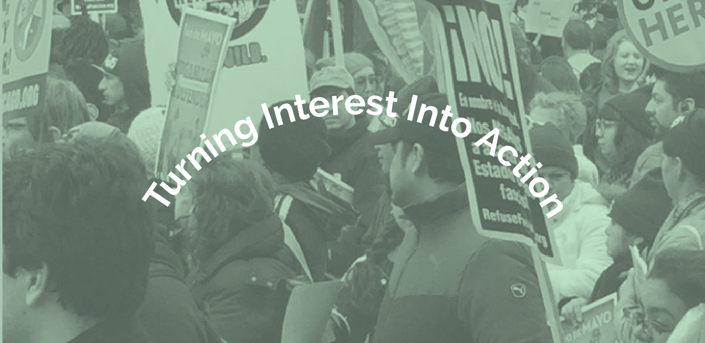 Crowd of people protesting with "Turning Interesting Into Action" text