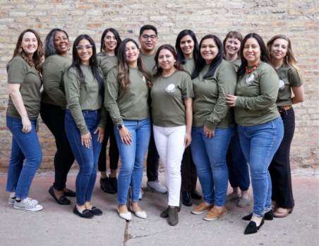 Group photo of people standing looking at camera.